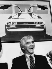 John DeLorean answers reporters' questions at a news conference in New York on Feb. 19, 1982. DeLorean developed the short-lived gull-winged sports cars featured as a souped-up time travel machine in the 