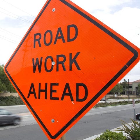 Road construction signs are seen posted along the 