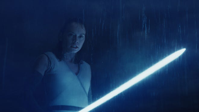 Seen here in "Star Wars: The Last Jedi," lightsaber-wielding heroine Rey (Daisy Ridley) returns in "Episode IX."