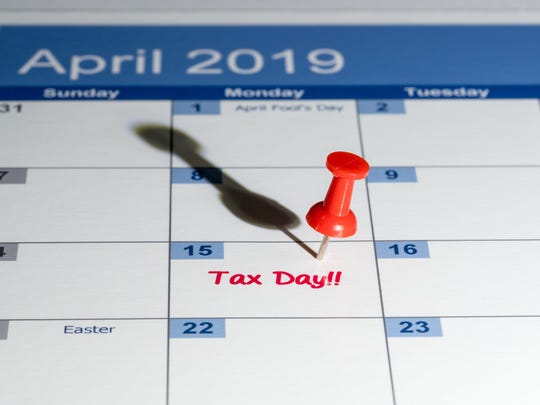 April 2019 calendar with pin on 4/15 and the words tax day written in red