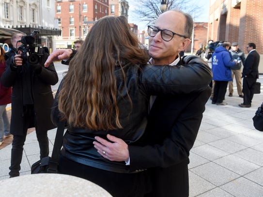 While the attorney for his son, Zachary, talks to the press, Ron Witman is embraced outside of the York County Judicial Center. Zachary on Thursday accepted a plea deal that would have him eligible for parole this time next year.