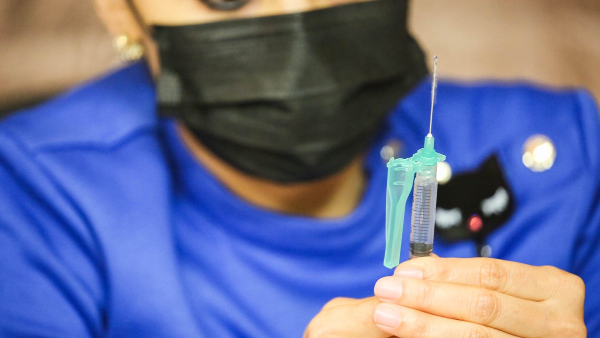 A vaccine is prepared during a COVID-19 vaccine clinic at the New Mexico Farm & Ranch Heritage Museum in Las Cruces on Oct. 19.