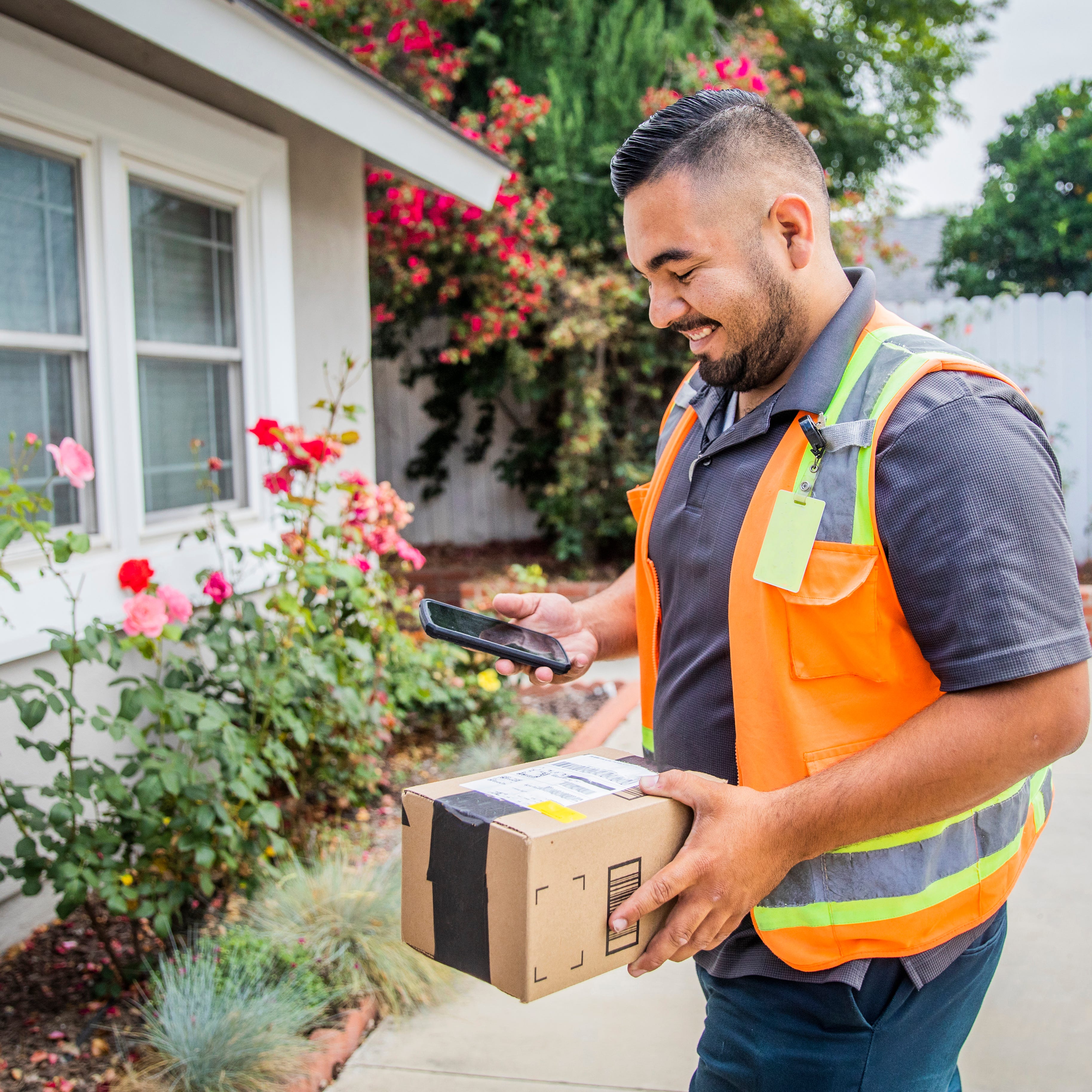 Delivery driver with package for home delivery.