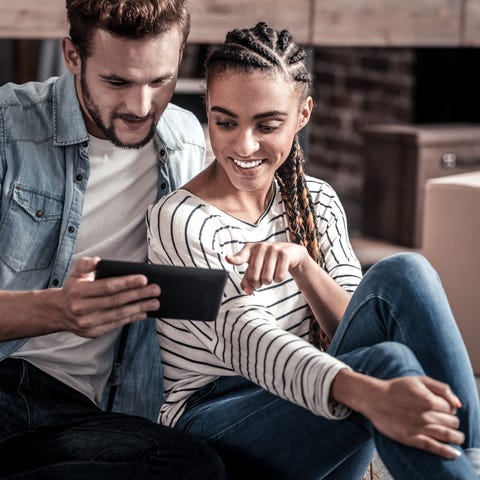 Young man and woman looking at a smartphone...