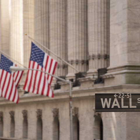 American Flags on a building by a Wall Street sign