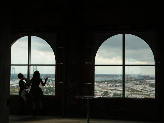 People get a view of Detroit from the 13th floor of Michigan Central Station in Detroit in September 2017 during Crain's Detroit Homecoming IV event.