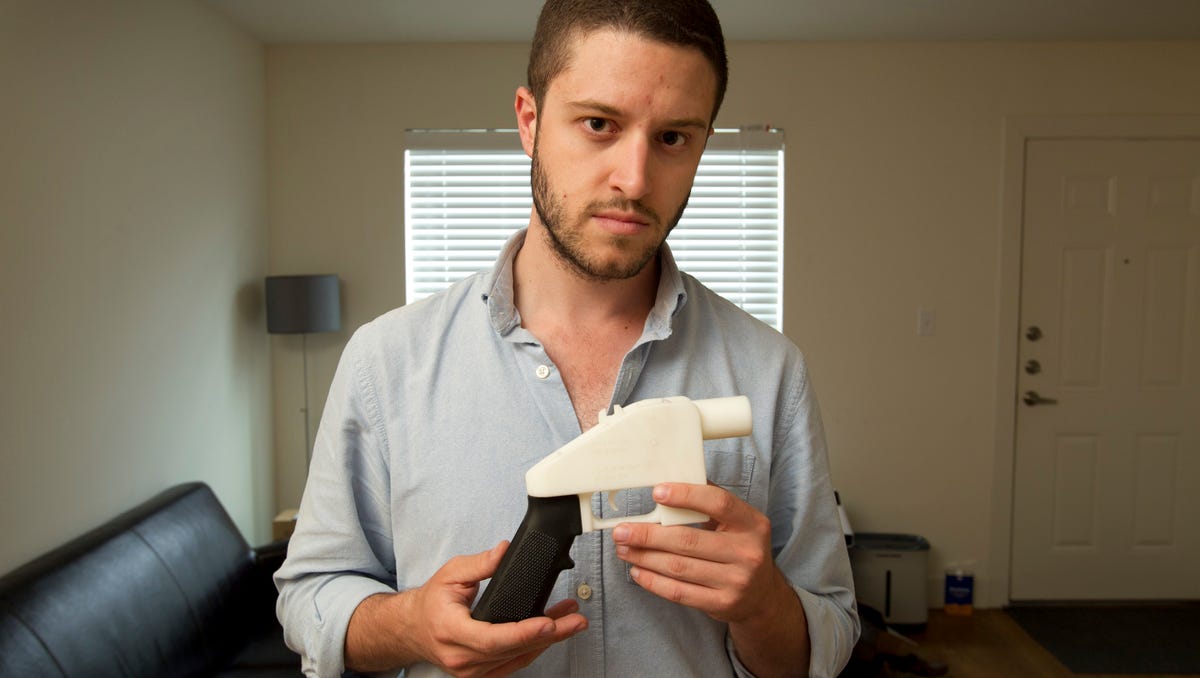 Cody Wilson, the founder of Defense Distributed, shows a plastic handgun made on a 3D printer at his home in Austin, Texas.