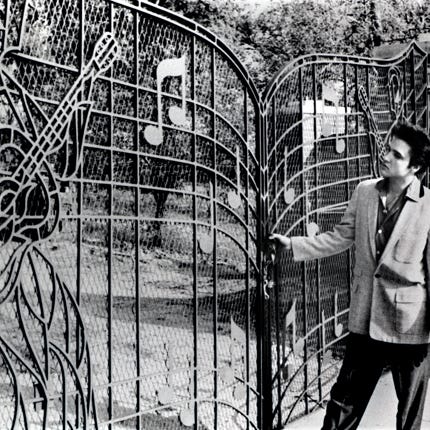 Elvis Presley at the gates of Graceland in 1957