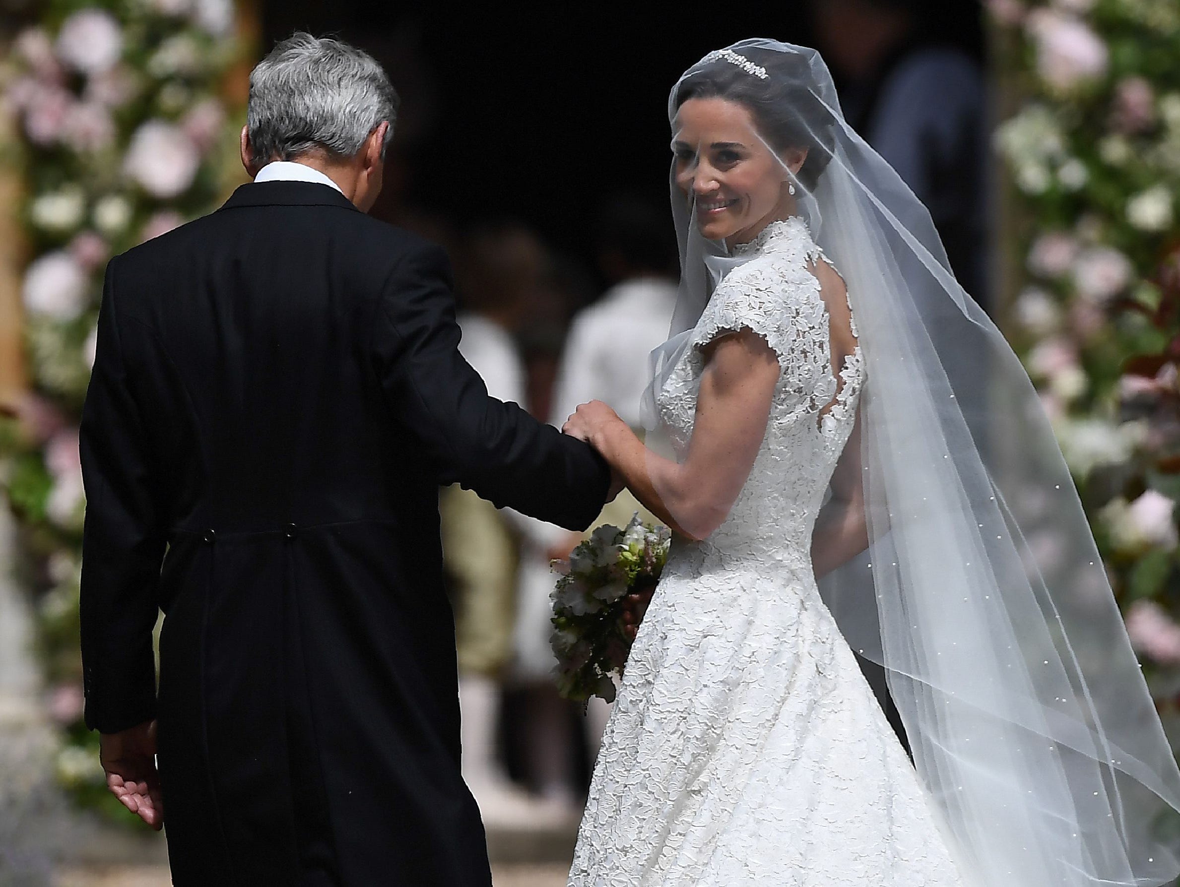 Pippa Middleton, escorted by her father Michael Middleton, as she arrives for her wedding to James Matthews at St Mark's Church in Englefield, on May 20, 2017.