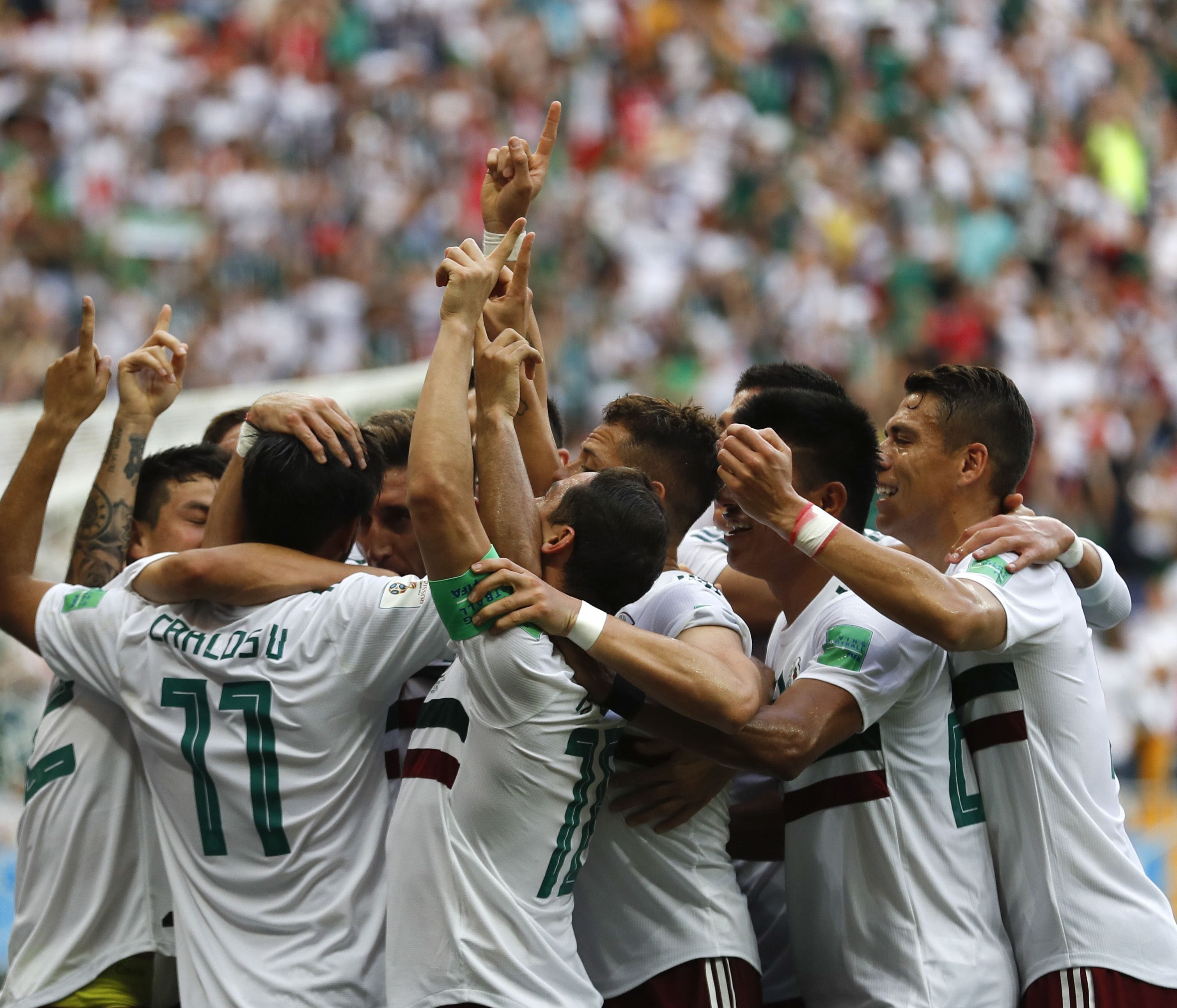 Mexico's Carlos Vela, left, celebrates with teammates after scoring the opening goal during the group F match between Mexico and South Korea at the 2018 soccer World Cup in the Rostov Arena in Rostov-on-Don, Russia, Saturday, June 23, 2018. (AP Photo