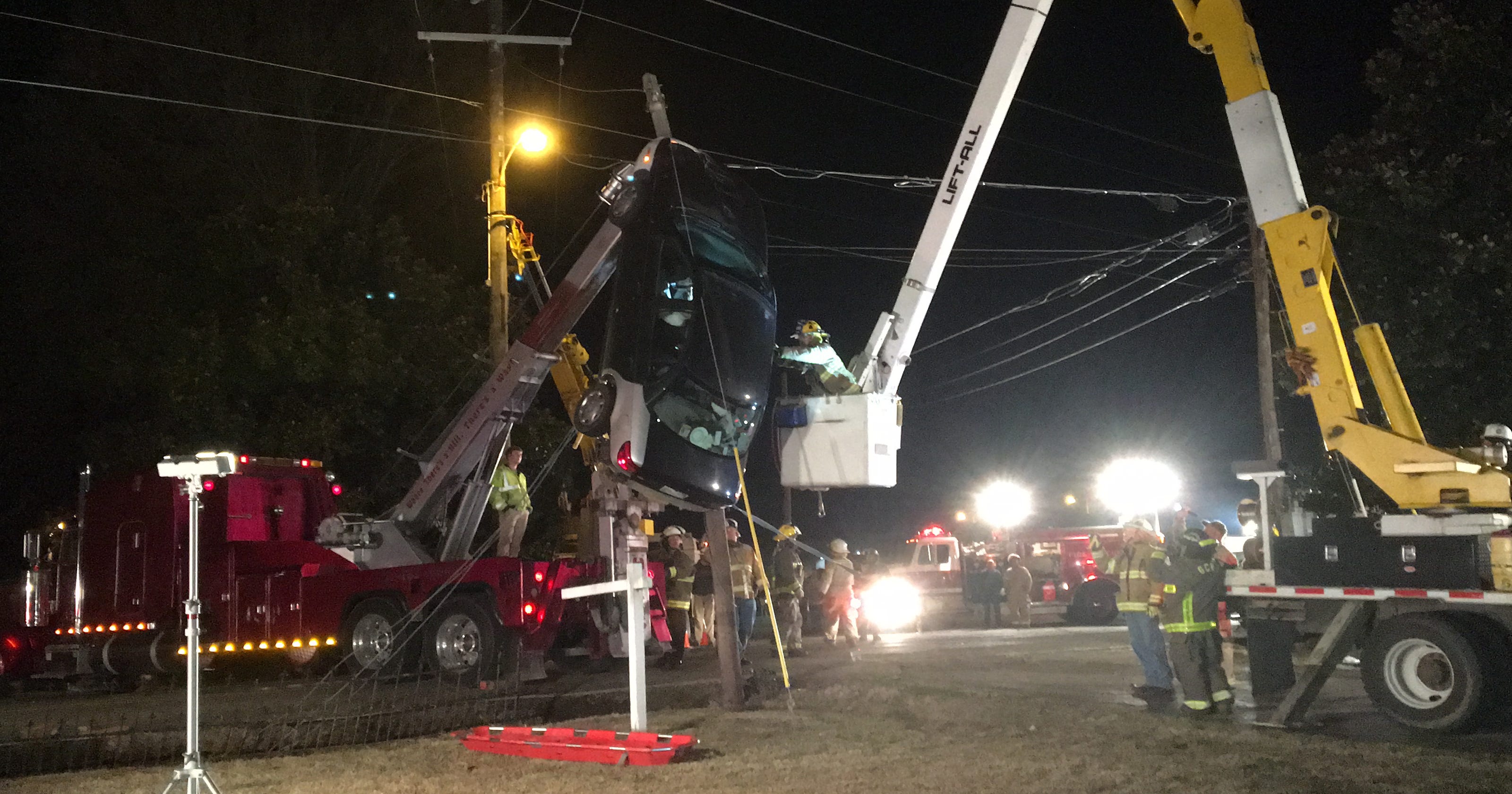 Woman rescued after car gets stuck in power lines