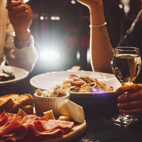 Two people enjoying dinner and wine at a fancy res