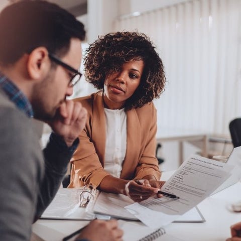 A couple decides whether to sign a mortgage agreem