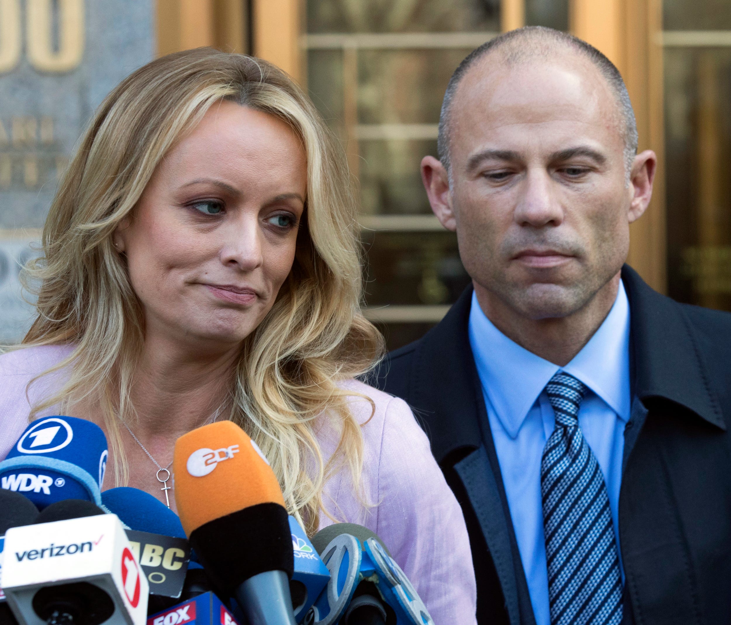 In this April 16, 2018 file photo, adult film actress Stormy Daniels, left, stands with her lawyer Michael Avenatti as she speaks outside federal court, in New York.