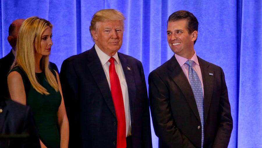 Donald Trump waits with daughter Ivanka Trump and son Donald Trump Jr. before speaking at a news conference on Jan. 11, 2017, in New York.