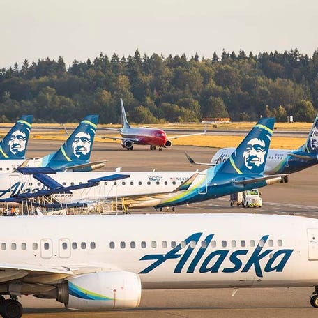 Several Alaska Airlines planes parked on the tarmac