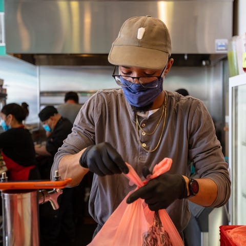 Fast-food worker bagging up an order.