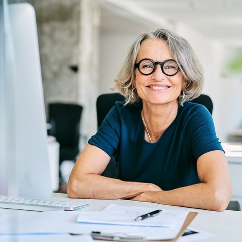 Smiling woman at a desk.