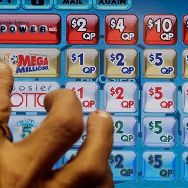 FILE - In this Dec. 17, 2013 file photo a clerk prepares to operate a lottery machine to print out Mega Millions lottery tickets for a customer in Muncie, Ind. Winning tickets for the March 18, 2014 drawing for an estimated $400 million jackpot were sold in Maryland and Florida.