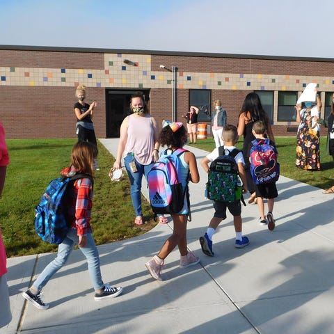 Children are greeted and applauded as they arrive 