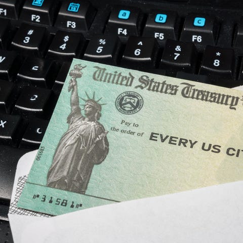 Government-issued check lying on a computer keyboa