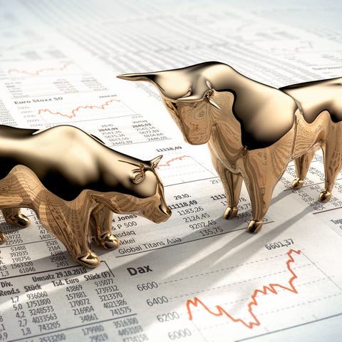 Golden bull and bear on stock pages