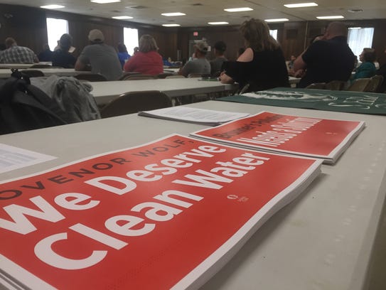 Free signs from the Sierra Club sit on a table near