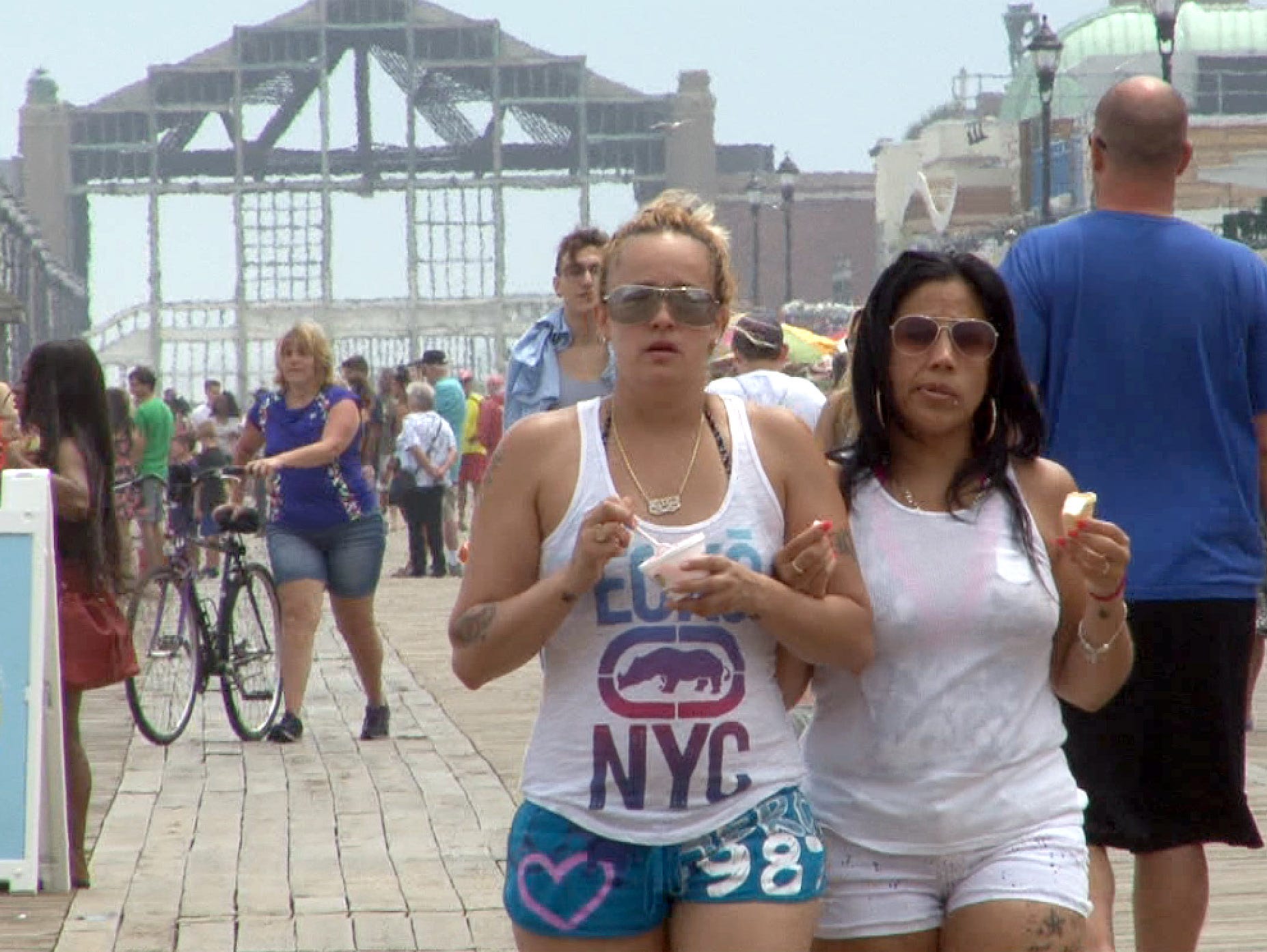 Jessica Acevedo (left) and her girlfriend Diane Ortiz, Perth Amboy, walk on the Asbury Park boardwalk Thursday, July 7, 2016.