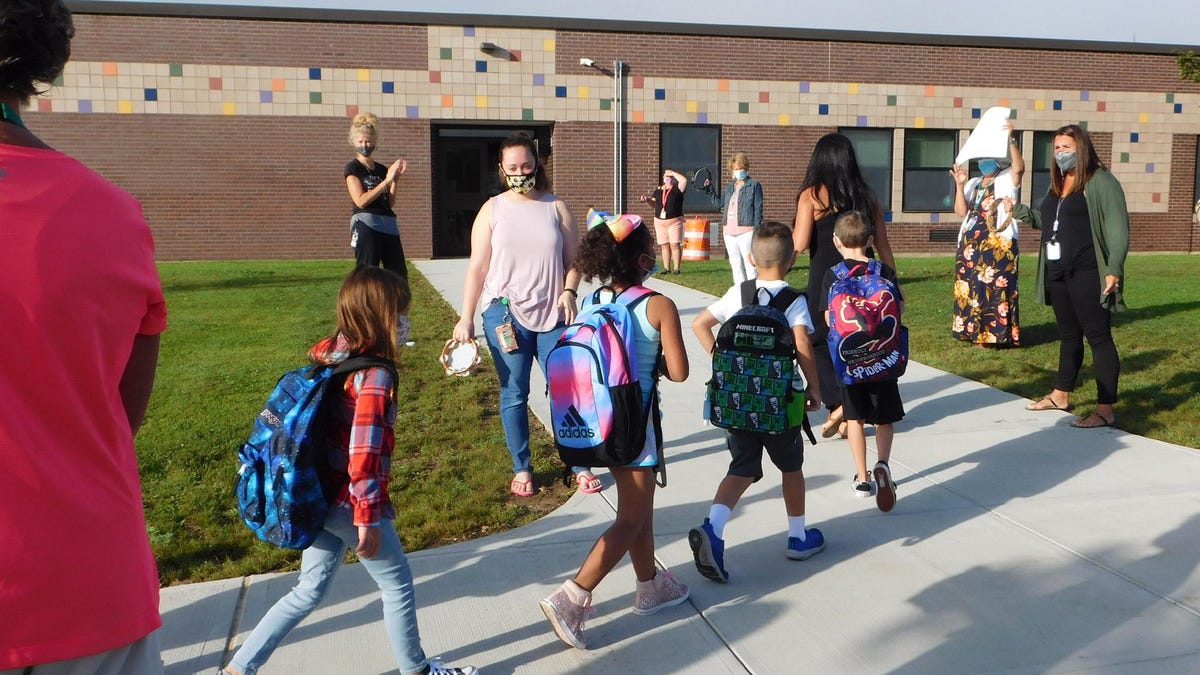 Children are greeted and applauded as they arrive Thursday, Sept. 3, 2020, for opening day at Herkimer Elementary School.