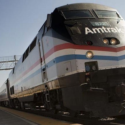 An Amtrak train passes through the Galesburg Amtrak station.