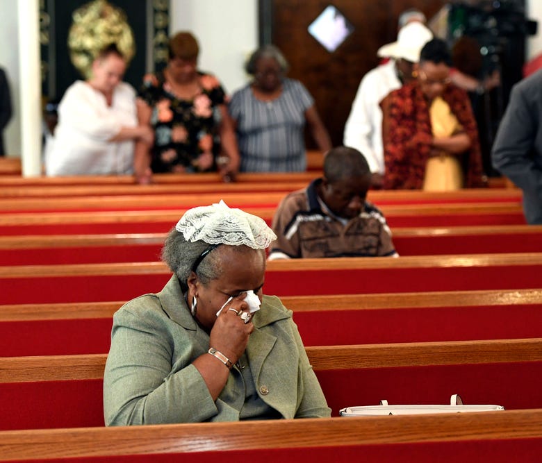 A woman weeps during mass at Galilee Baptist Church held in the wake of the shooting at the Art All Night Festival in Trenton, NJ early Sunday, June 17, 2018.