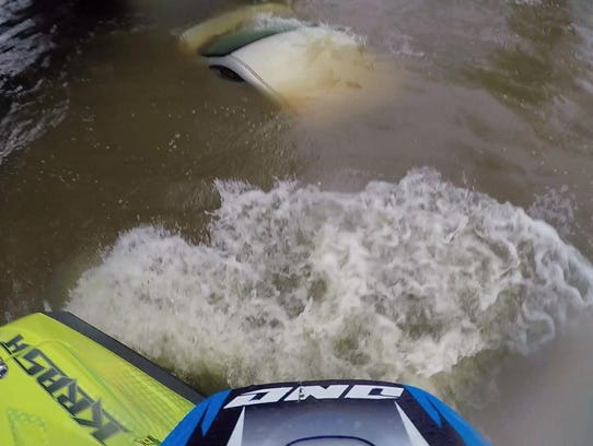 A submerged car can be seen from a Kalamazoo street