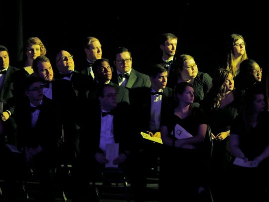 The Hanover College Concert Choir is bathed in yellow