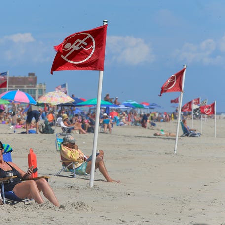 Red flags mark areas of “no swimming” in the ocean, where a hazard warning of potential rip currents has been issued, in Ocean Grove, NJ Tuesday August 30, 2016.