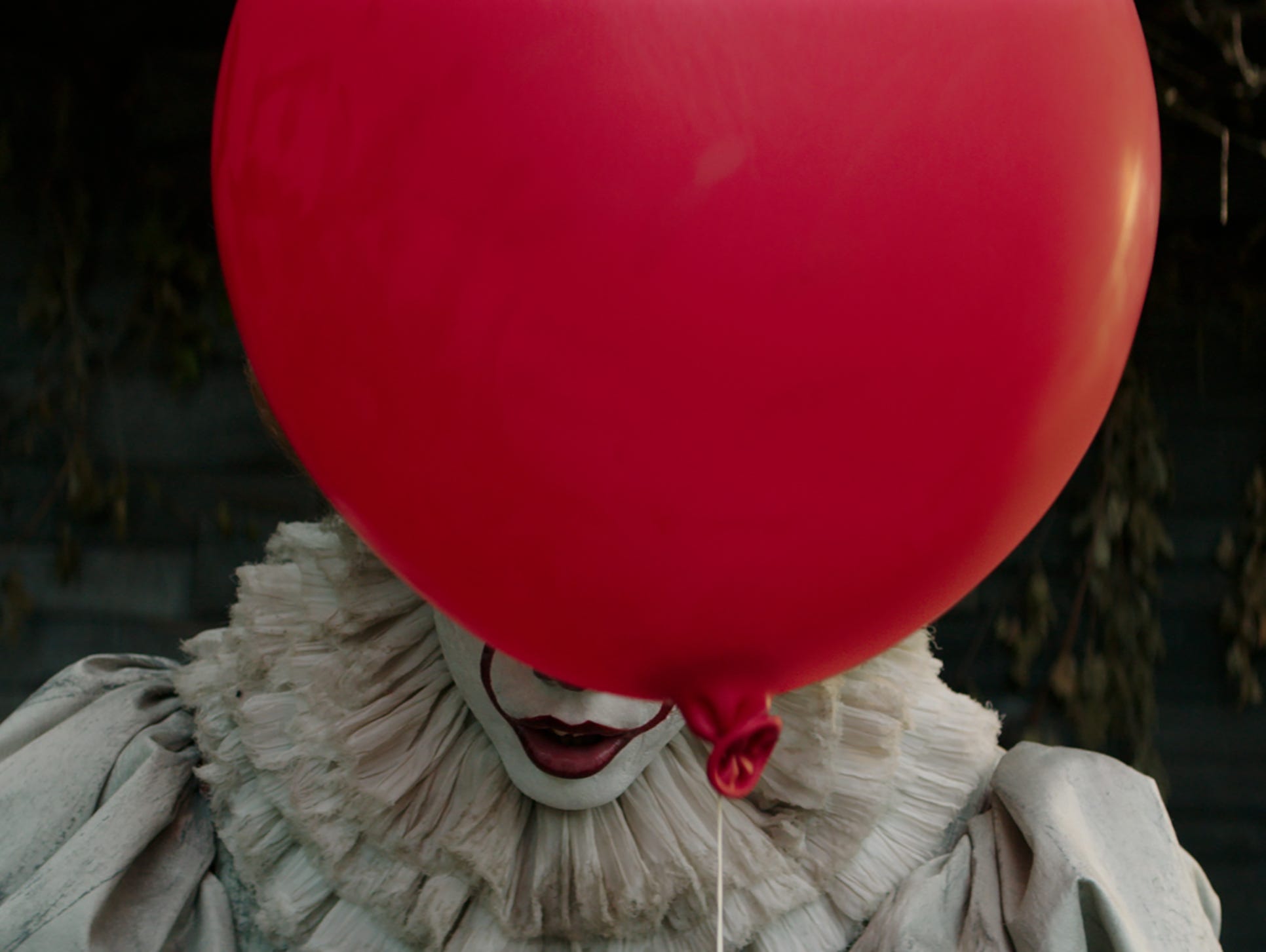 A red balloon is synonymous with the killer clown Pennywise (Bill Skarsgård) in the horror film 'It.'