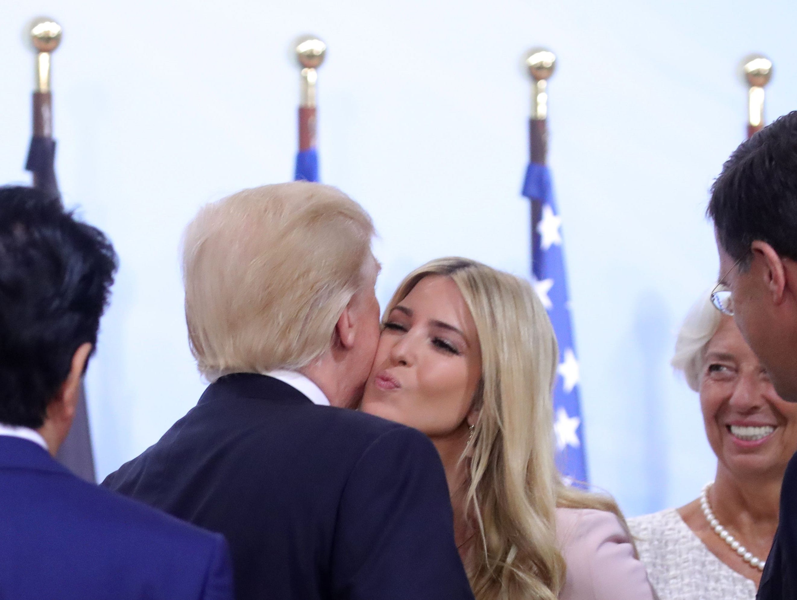 President Trump kisses his daughter Ivanka Trump as they attend a panel discussion about women's entrepreneurship during the G-20 summit in Hamburg Saturday.