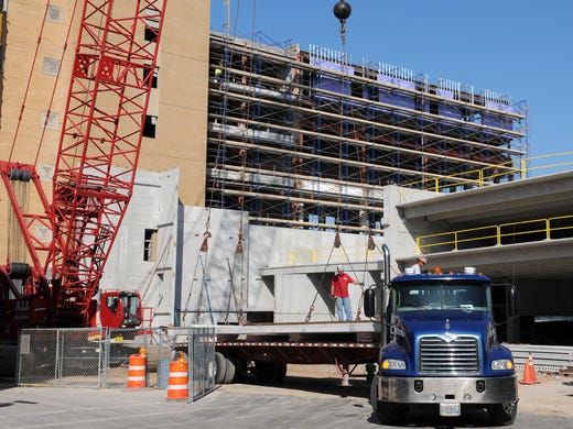 Workers unload concrete panels during renovation of