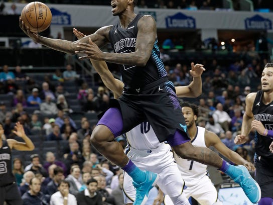 Charlotte Hornets' Marvin Williams, front, drives past Memphis Grizzlies' Ivan Rabb during the first half of an NBA basketball game in Charlotte, N.C., Thursday, March 22, 2018. (AP Photo/Chuck Burton)