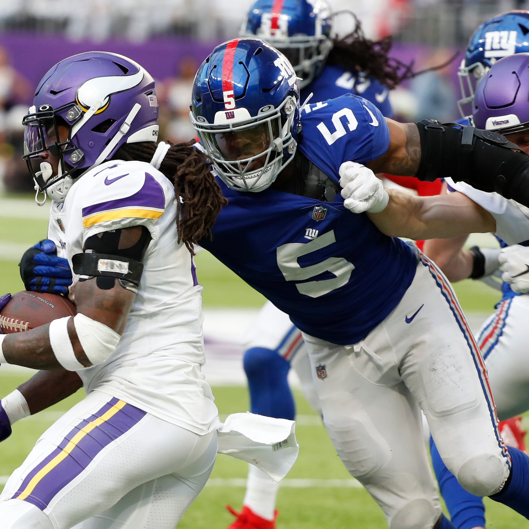 Minnesota Vikings running back Dalvin Cook runs from New York Giants defensive end Kayvon Thibodeaux (5) during the second half of an NFL football game, Saturday, Dec. 24, 2022, in Minneapolis. (AP Photo/Bruce Kluckhohn)