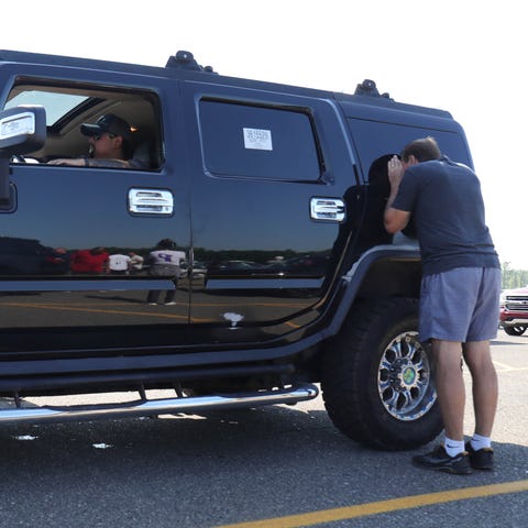 A customer checks out this Hummer as it waits to g