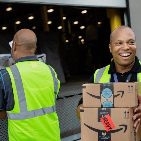 Amazon workers unloading a truck.