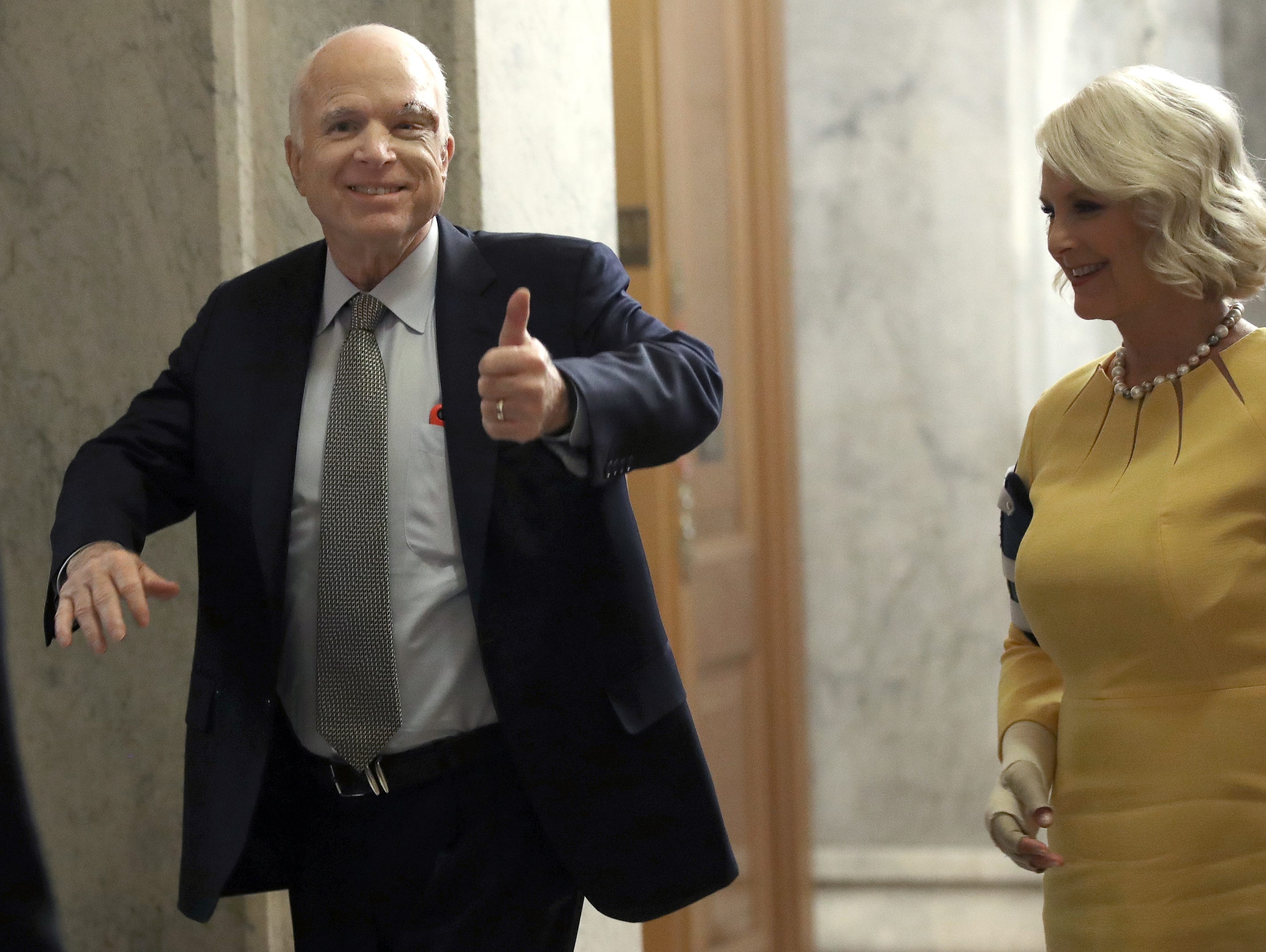 Sen. John McCain returns to the U.S. Senate, accompanied by his wife, Cindy, on July 25, 2017.