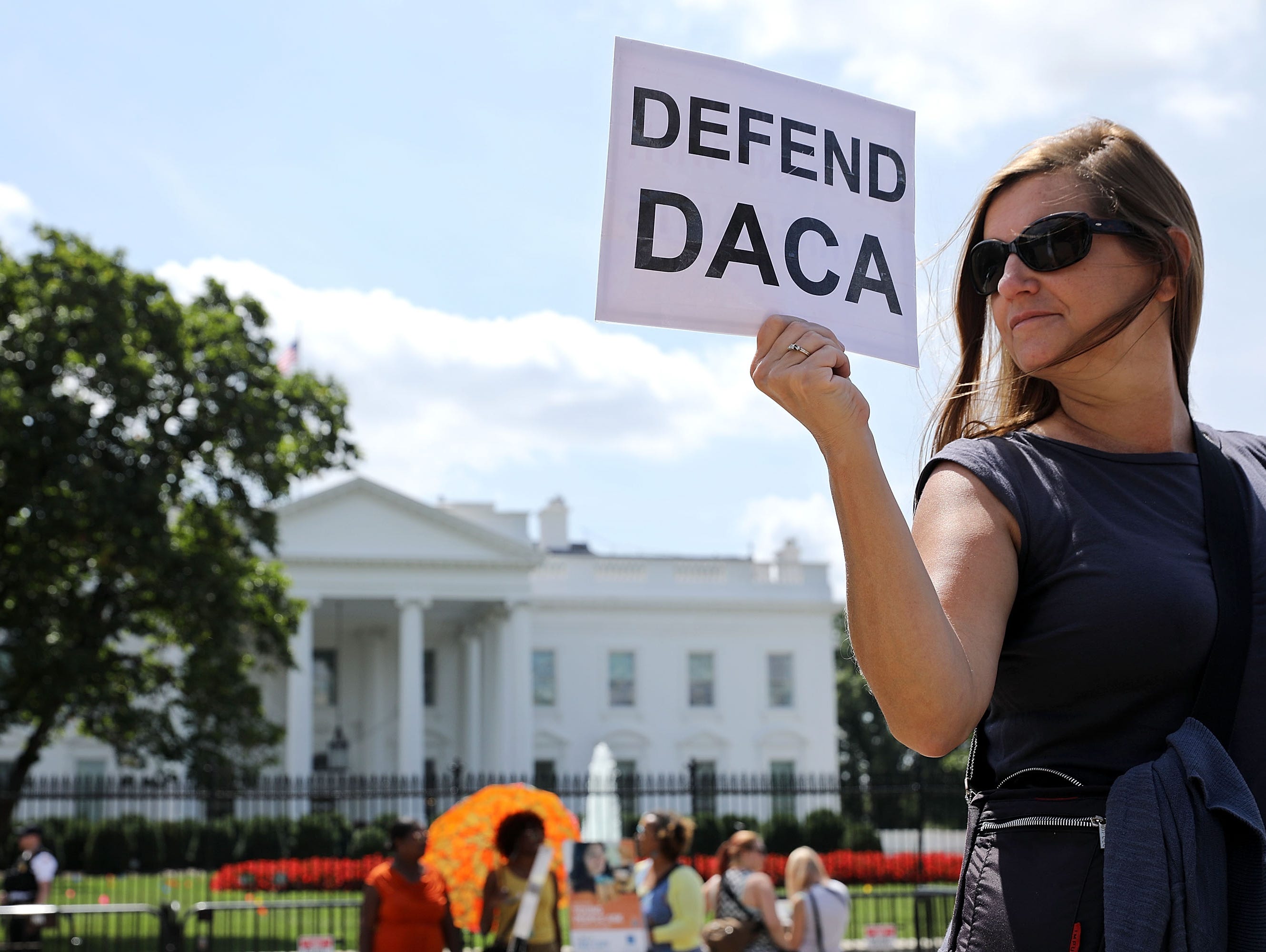 Protesters demonstrate outside the White House on August 30, 2017, to urge President Trump to maintain the Deferred Action for Childhood Arrivals program, or DACA, which protects young undocumented immigrants from deportation.