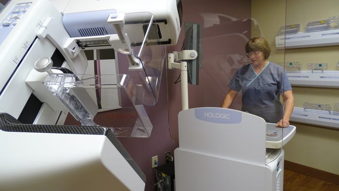 Mammography technologist Arlene Donaldson operates a 3-D mammography machine at ProMedical Memorial Hospital in Fremont.