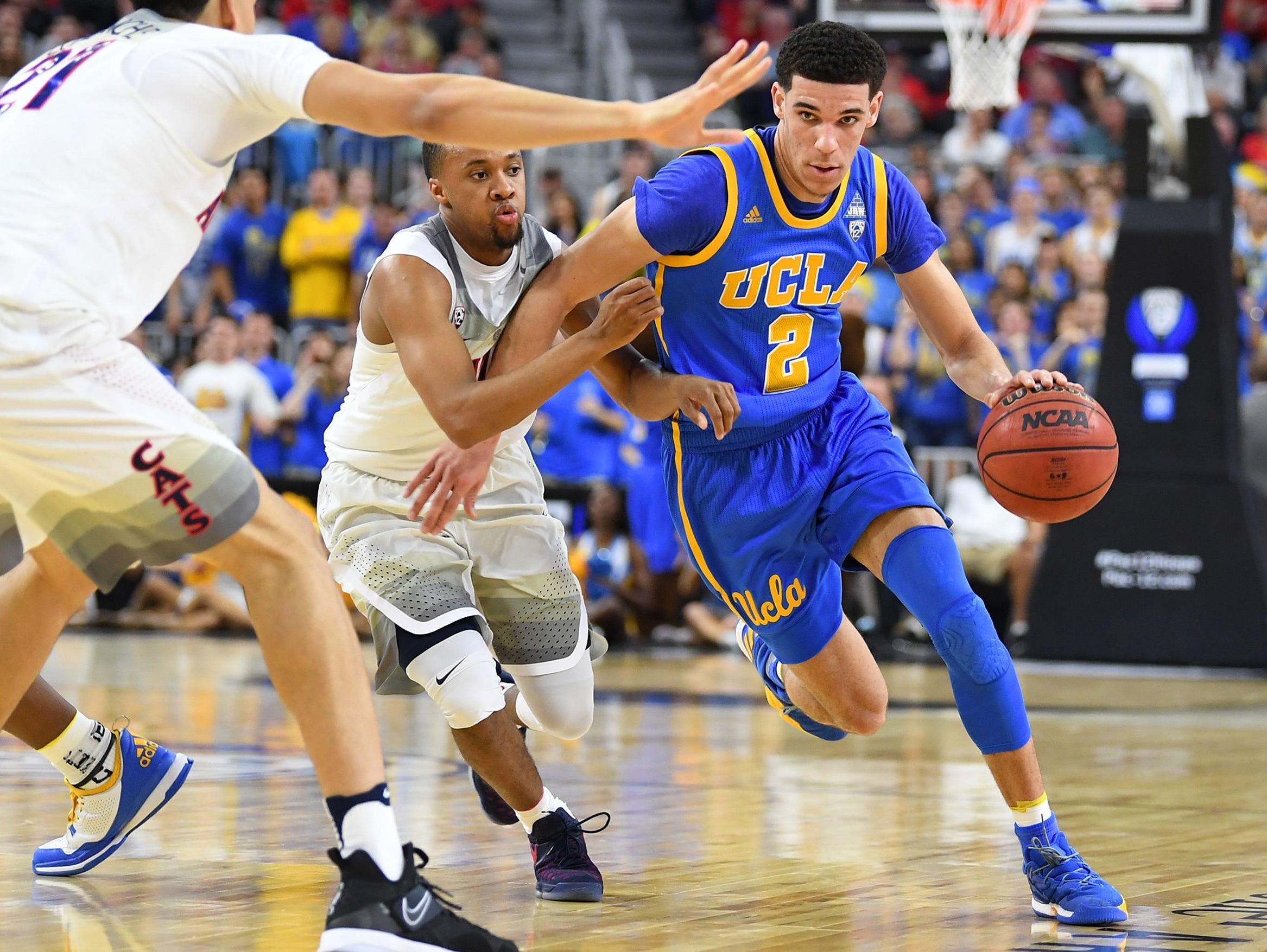 UCLA Bruins guard Lonzo Ball (2) dribbles past the defense of Arizona Wildcats guard Parker Jackson-Cartwright (0) during the Pac-12 Conference Tournament at T-Mobile Arena.