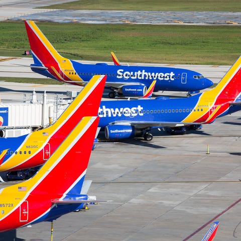 Southwest Airlines planes in an airport gate area.