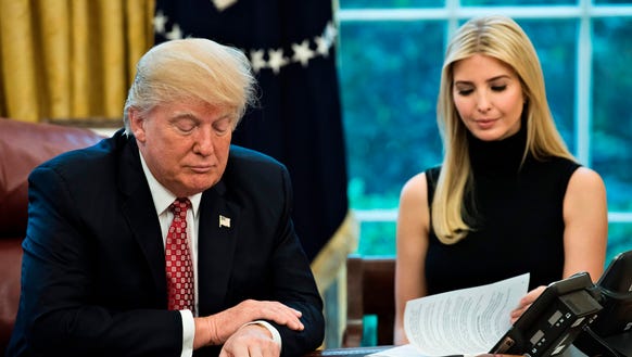 President Trump and daughter Ivanka Trump look at their