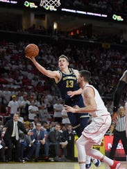 Michigan forward Moritz Wagner goes to the basket against