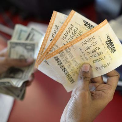 A customer purchases Mega Millions lottery tickets in Tallapoosa, Ga., Tuesday.