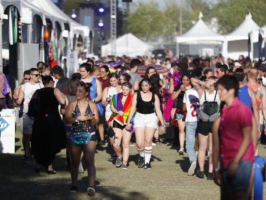 Pride attendees make their way among the vendors during